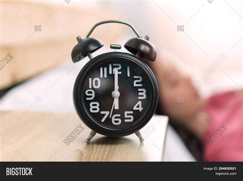 Set alarm for 6:05 AM .